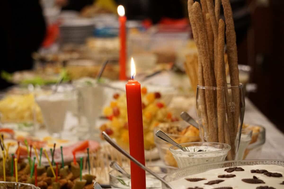Holiday Meal with a Variety of Food on Table with Lit Candles